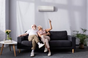 senior-couple-on-couch-mini-split-on-wall